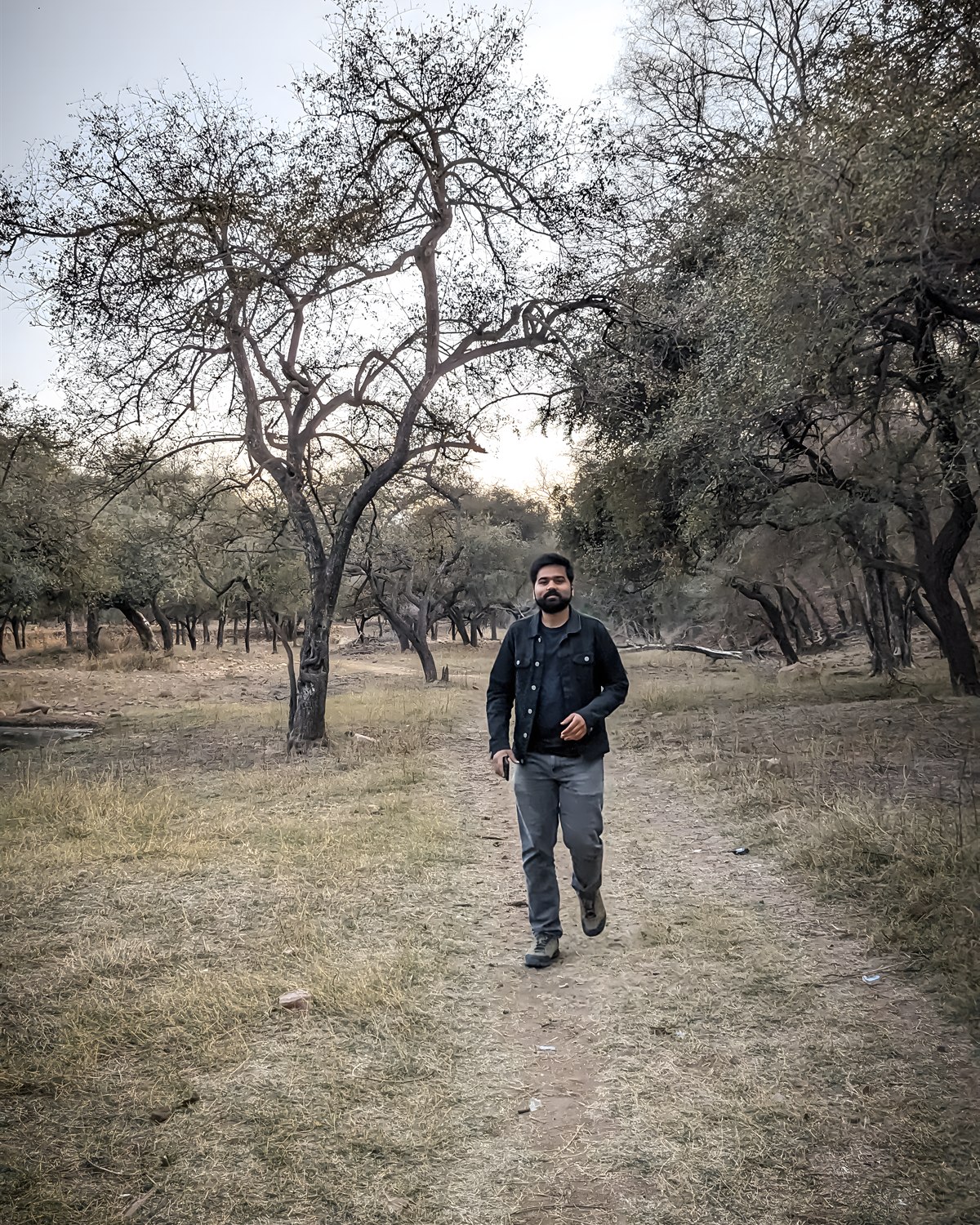 Adarsh Singh walking through a wooded landscape